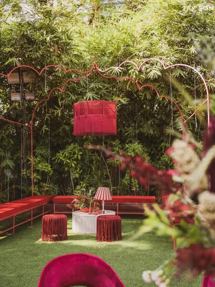 Another angle of the "Red Affair" lounge, showing the unique hanging fabric chandelier that centers the space.