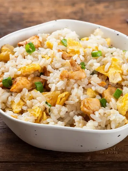 A simple and classic chicken fried rice. The clean styling and wooden background make it a versatile image for any Pan-Asian menu.