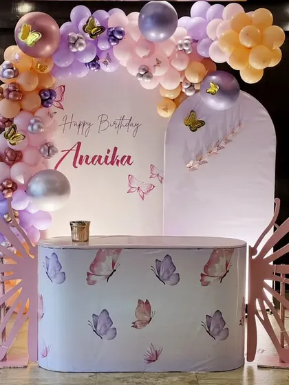 This whimsical butterfly theme is perfect for a magical birthday. It features a pastel balloon arch, custom-printed table, and large, elegant butterfly wing cutouts that make for a beautiful photo opportunity.