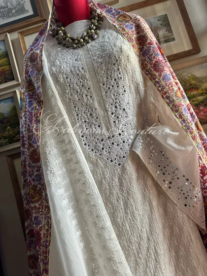 A detailed shot of the sleeve and torso, showing the precise placement of mirrorwork within the Chikankari patterns, a testament to our focus on understated luxury.