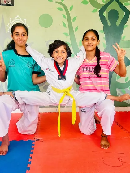Another variation of the three-person flexibility pose, showing the fun and camaraderie in our classes.
