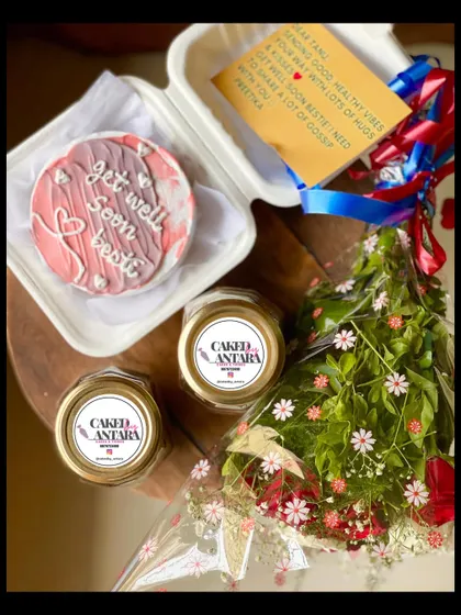 The perfect way to send some cheer. This "get well soon" package includes a personalized bento cake, two comforting cake jars, a beautiful bouquet of fresh flowers, and a handwritten note to lift their spirits.