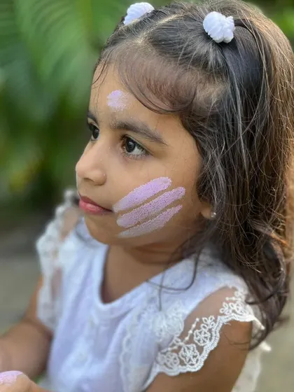 A sweet moment of a child enjoying my safe and natural Holi colors. I love seeing my products bring smiles to people's faces.