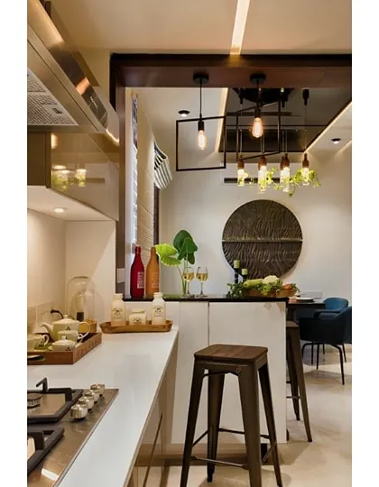 A minimalist white breakfast counter is perfect for this compact, open kitchen. It provides a functional dining spot without overwhelming the space.