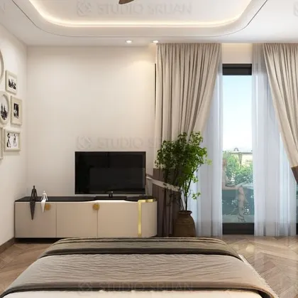 This view showcases the opposite wall of the bedroom, with a clean, minimalist TV console and a gallery wall of personal photos, adding a personalized touch to the modern design.