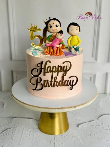 A special cake for a grandma's 50th birthday, topped with a beautiful figurine of her with her grandchildren.