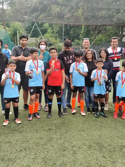 Players showing off their medals with their proud parents. I believe in celebrating every participant's hard work.