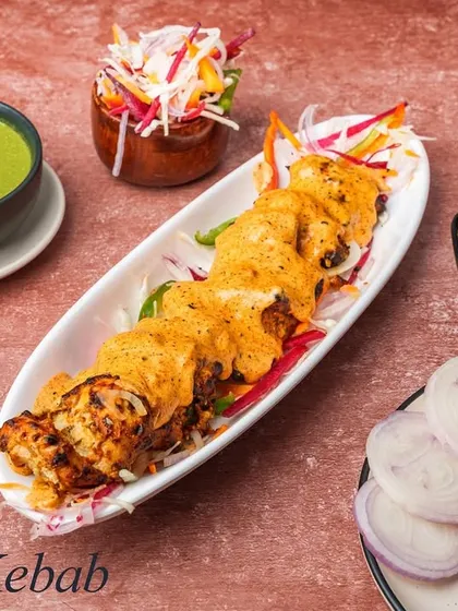Our Thaina Kebab is a unique offering where tender kebabs are wrapped in a thin, roomali-like bread before being grilled. This keeps the kebab incredibly moist and adds an interesting textural layer.