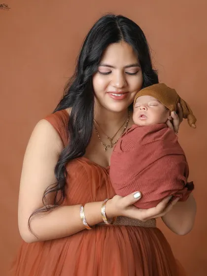 A new mother admiring her sleeping baby. The warmth and love in this photo are palpable.