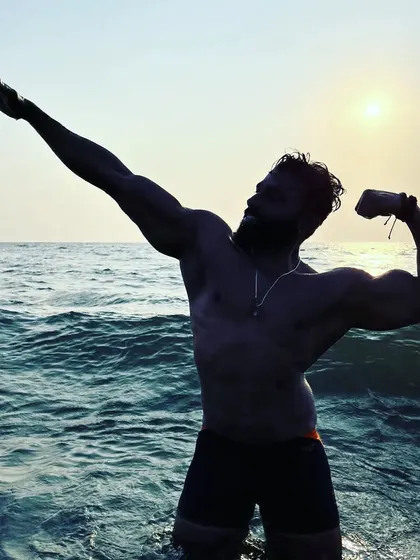 Feeling strong and free in the ocean. This is a moment of pure enjoyment, powered by the discipline and strength forged in the gym.