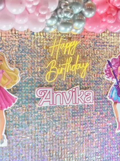 Detail shot of the Barbie backdrop with a neon 'Happy Birthday' sign.