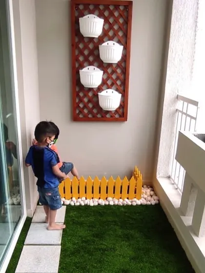 We create spaces where memories are made. This small balcony was transformed into a mini-garden with turf, a decorative fence, and wall planters, giving this little one a safe and green space to play.