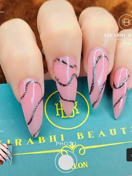 A trendy and abstract design with long, stiletto-shaped extensions. I used a sheer pink base and added wavy, textured silver-black lines for a modern artistic feel.