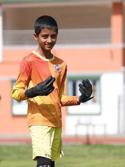 A happy and confident goalkeeper during a match on our Ooty tour. We build players who love the game.