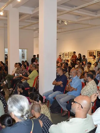 A wide view of the packed audience at the artist talk.