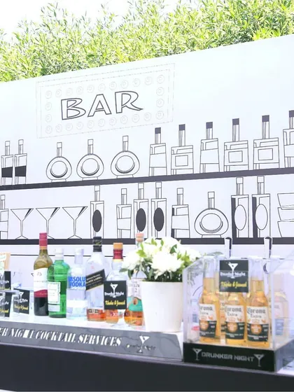 The bar setup for the 'Line Art Carnival', featuring a custom-drawn backdrop that turns a simple bar into a piece of art.