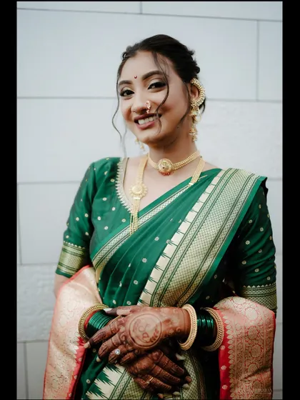 A beautiful, happy portrait of the bride. The soft tendrils framing her face add a touch of modern romance to her traditional look.