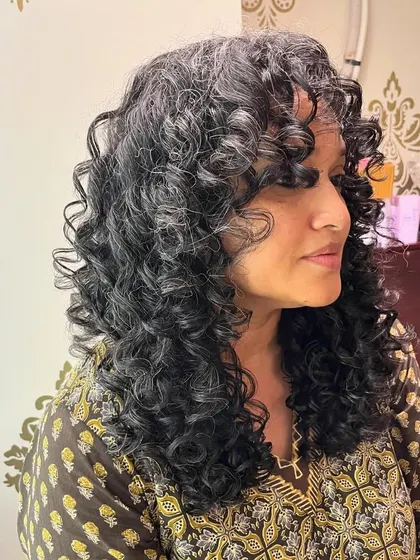 A beautiful curl transformation for Shivali, complete with bangs to frame her face.