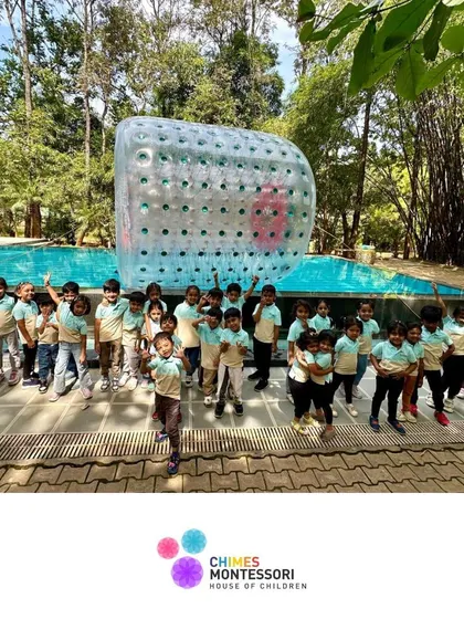 A group photo of our happy explorers at Discovery Village, with a giant zorb ball in the background promising more fun to come.