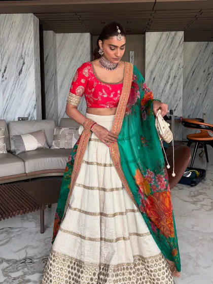 The final re-styled look of my Sabyasachi Roka lehenga. The white skirt with a red blouse and green floral dupatta is a classic and versatile combination.