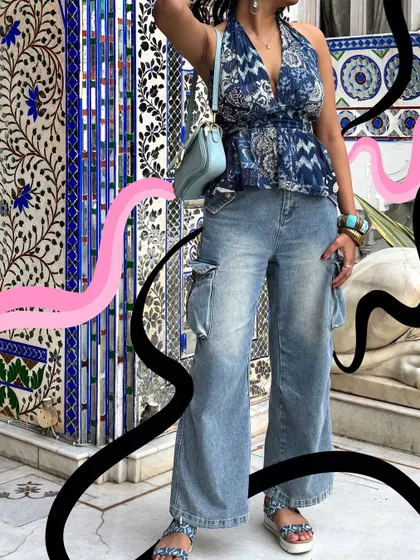 An all-blue outfit in front of a beautiful blue tiled wall, with black and pink doodles for a cool contrast.