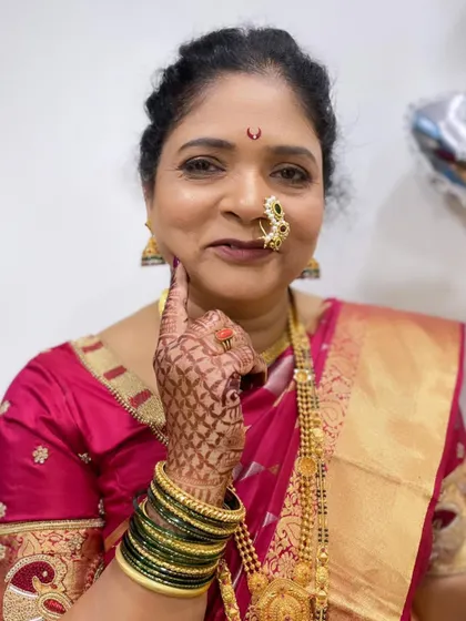 A playful pose from the mother of the groom, showing off her beautiful makeup and traditional jewelry.