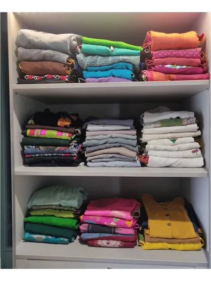 For this client, we stacked casual suits and kurtas by color on open shelves. This method makes it easy to see everything at a glance and pull out exactly what you need.