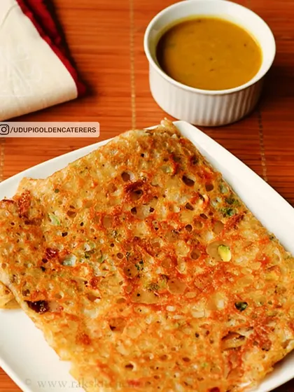 Our crispy Rava Dosa, made from semolina batter and folded neatly. It is served with a side of flavorful sambar, a popular choice for breakfast and tiffin services.