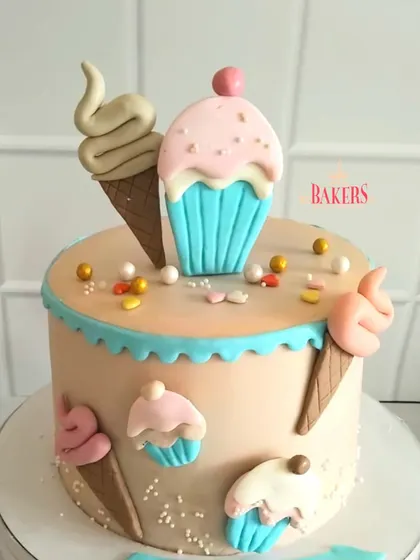 Cuteness overload with this Candyland-themed cake for Aahana's 9th birthday. The cake is decorated with fondant ice cream cones and cupcakes in sweet pastel colors.
