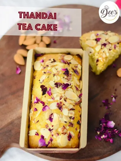 A close up of our special Thandai Tea Cake, a Holi favorite. This moist and flavorful cake is infused with the traditional taste of thandai and topped with almonds and dried rose petals.