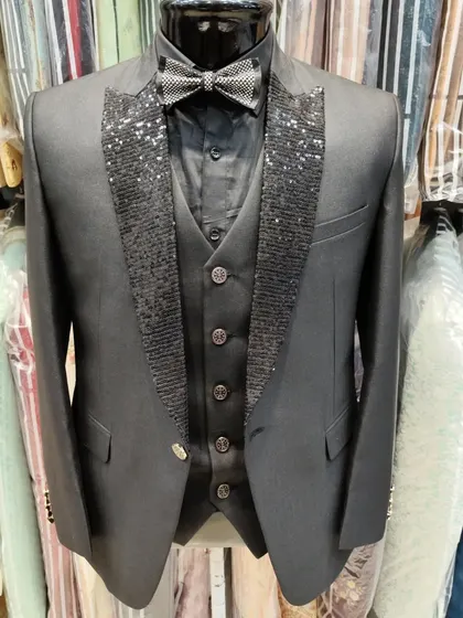 For a bold, unforgettable party look. This custom three piece suit features a striking black sequin lapel and a matching bow tie, designed to catch the light and ensure you are the center of attention.