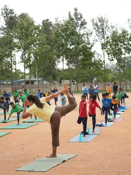 Leading a large group of school children in Natarajasana (Dancer's Pose) on International Yoga Day.