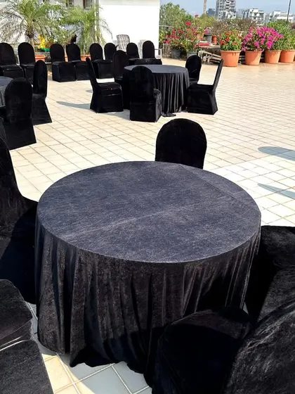 An elegant seating arrangement for a Diwali party on a terrace at Pali Hill. We used round tables with black velvet covers and matching chair covers for a chic and sophisticated look.