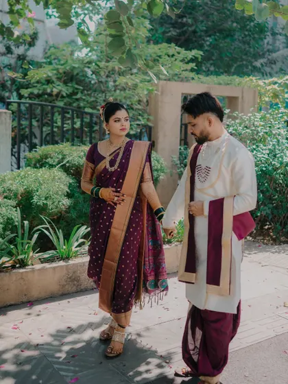 A quiet, thoughtful moment between the couple. Holding hands, they share a gentle look that speaks of their deep understanding and connection.
