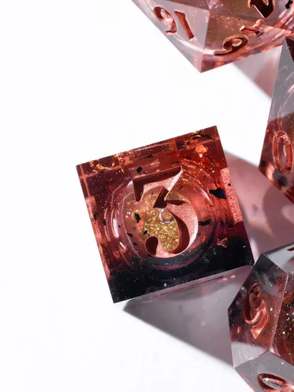 A macro shot of a single die from Wild Earth Dice. This extreme close-up reveals the incredible detail, glitter, and depth within the resin, showcasing the craftsmanship of the product.