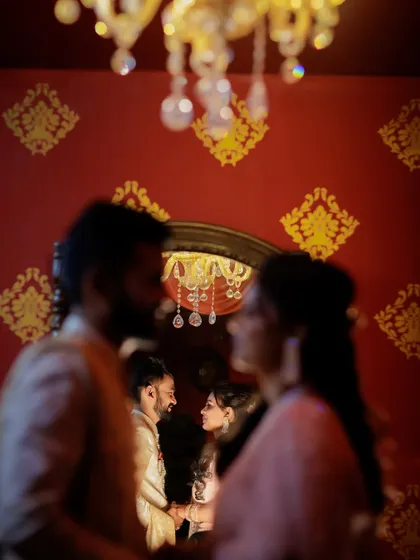 An artistic shot using reflection and a shallow depth of field to create a dreamy, intimate portrait in a richly decorated room.
