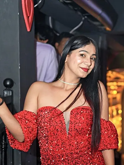 A guest looking stunning in a sequined red dress, perfectly dressed for the occasion.
