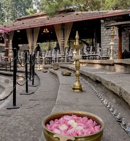 The walkway at the venue, decorated with brass urlis filled with pink petals.