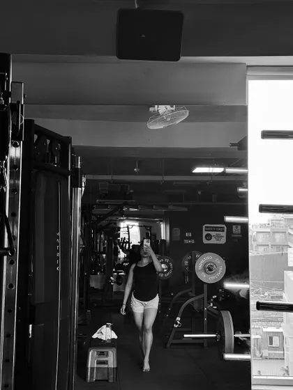 A full-body mirror selfie showing the gym environment. This is where the transformation happens, one workout at a time.