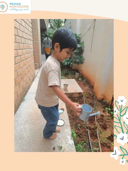 A student takes on the responsibility of watering the garden, a simple task that builds great confidence.