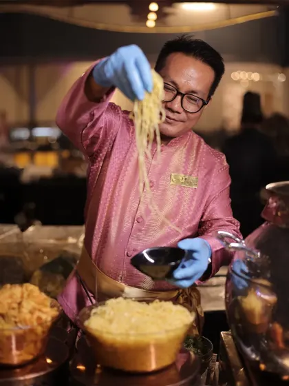 An expert from our Thai culinary team assembles a noodle dish. His focus and skill ensure that every bowl is a perfect balance of authentic Thai flavours and textures.