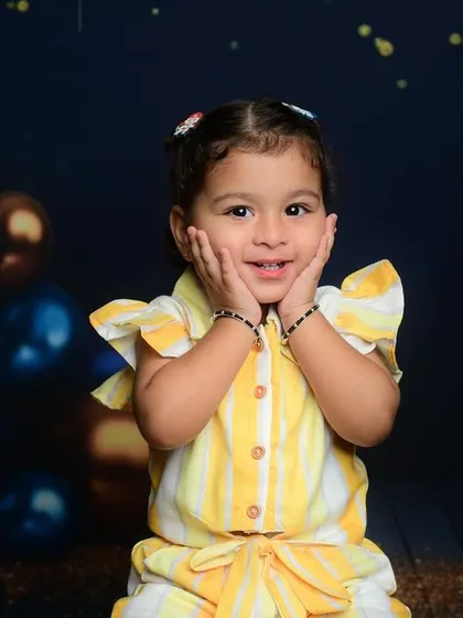An absolutely adorable photo of a little girl with a surprised and happy expression. Capturing these moments is what it's all about.