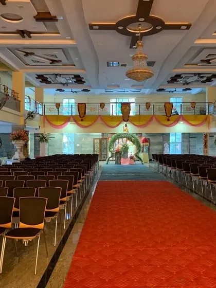 A wide view of the seating arrangement for the grand naming ceremony. The decor extends throughout the hall to create a cohesive and celebratory environment for all the guests.