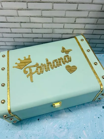 This mint green leatherette trunk offers a soft, modern color choice, personalized with a name and butterfly charm.