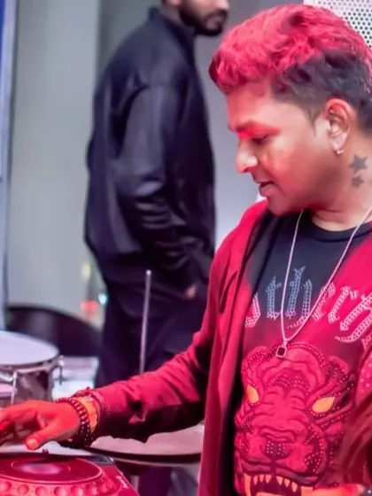 Sporting a different look with red hair for a special set. It's all about bringing a unique vibe to every performance, both in sound and style.
