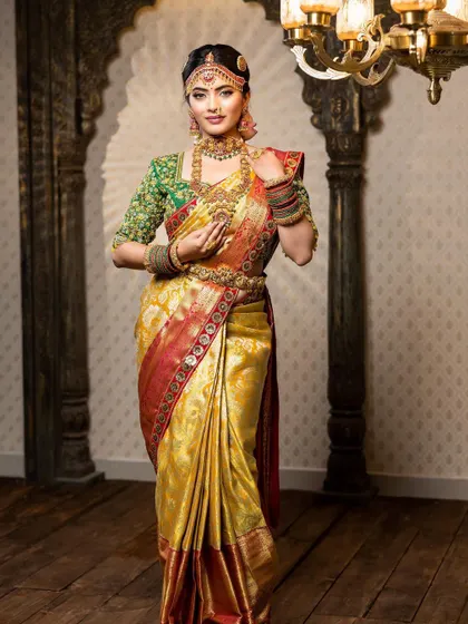 This detailed photoshoot showcases a complete South Indian bridal look, from the intricate matha patti and layered necklaces to the flawless airbrush makeup and traditional saree draping.