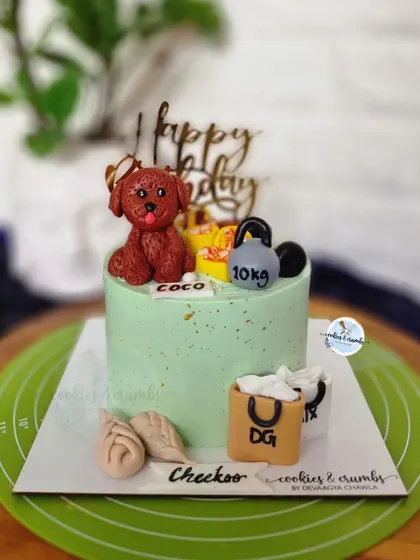 This cake is all about the birthday person's favorite things. It features a fondant dog, a kettlebell for the gym lover, shopping bags, and even little dumplings.