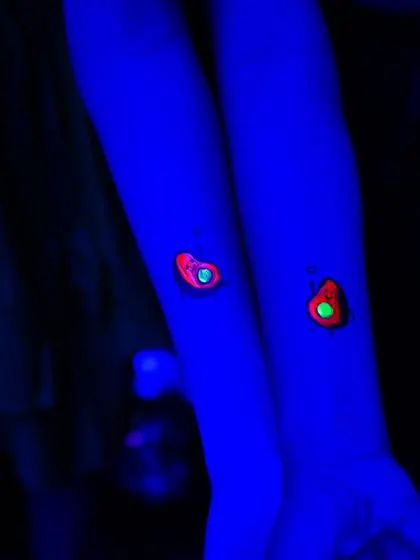 Glow-in-the-dark tattoos are a huge hit for neon-themed parties, lighting up under blacklight for a cool effect.