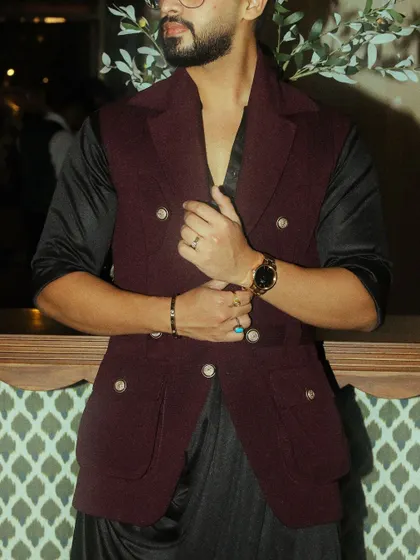 A detail shot of the burgundy waistcoat, highlighting the double-breasted design and custom buttons.