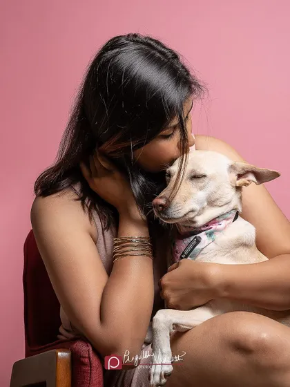 A tender moment between a mother and her beloved dog, Penny. Studio sessions are a wonderful way to capture the deep connection between pets and their people in a clean, focused setting.